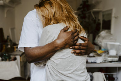 Son embracing mother in living room