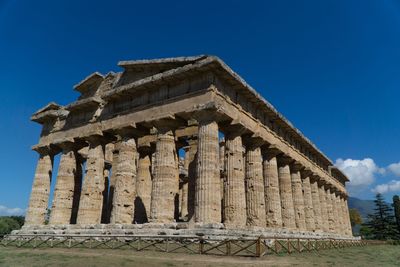 Low angle view of old temple against blue sky