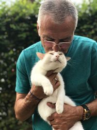 Full length of a man holding cat