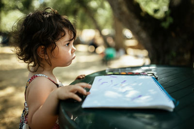 Girl looking away while using mobile phone