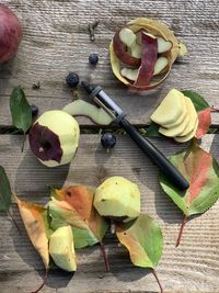 High angle view of fruits and leaves on table