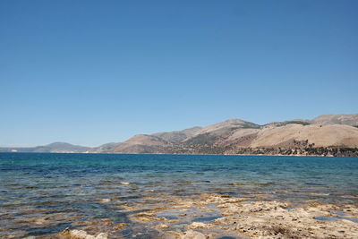 Scenic view of sea against clear blue sky