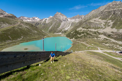 People on mountain against sky