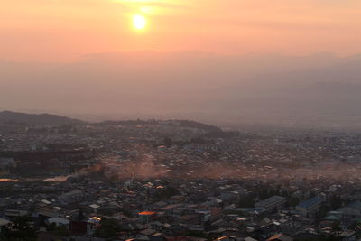 Cityscape against sky at sunrise