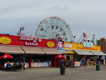 View of amusement park against cloudy sky