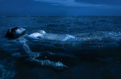 Woman in bikini swimming at sea 