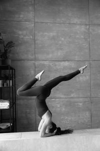 Low section of woman exercising on floor