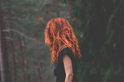 Woman standing in forest