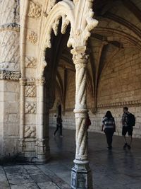 People walking in historic building