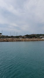 Scenic view of sea against sky in city