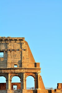 Low angle view of historical building against clear blue sky