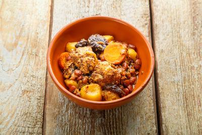 Jewish dish chelnt with meat on a wooden table in a plate. copy space horizontal photo