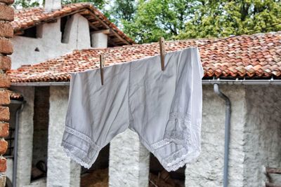 Clothes drying on clothesline against building