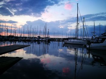 Boats in harbor at sunset