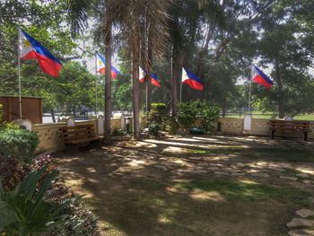 Scenic view of flag against trees