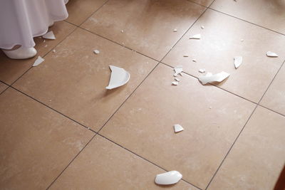 High angle view of white shoes on tiled floor