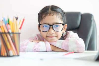 Portrait of boy sitting on table