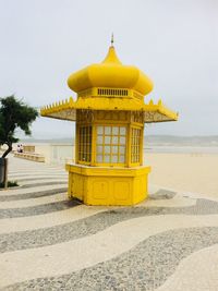Built structure on beach against clear sky