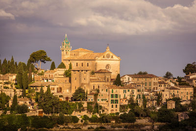 Buildings in city against cloudy sky, valldemossa, valldemosa