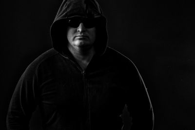 Man wearing mask against black background
