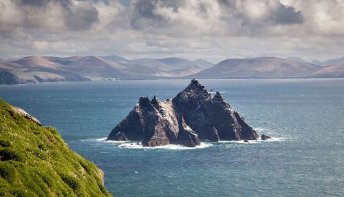 Scenic view of sea and mountains against sky