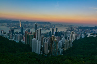 Aerial view of cityscape against sky during sunset