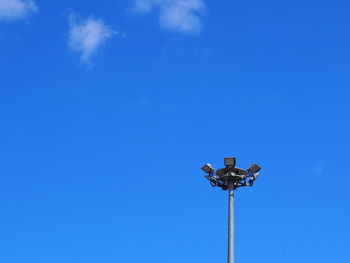 Low angle view of street light against blue sky