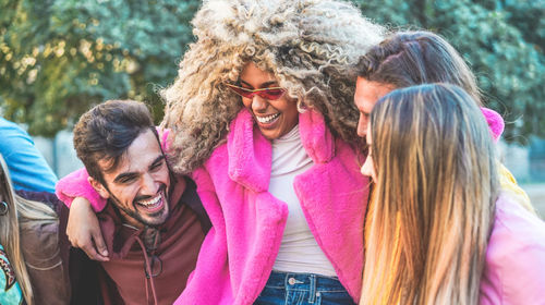 Smiling friends standing outdoors