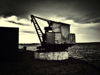 Abandoned building against cloudy sky