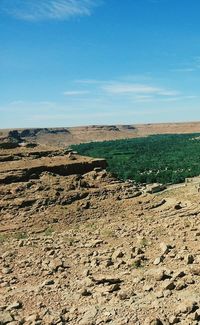 Scenic view of landscape against blue sky