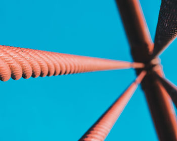 Low angle view of security camera against clear blue sky