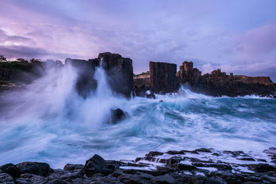 Scenic view of waterfall against sky