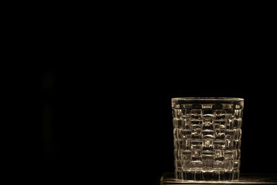 Close-up of illuminated lamp on table in dark room