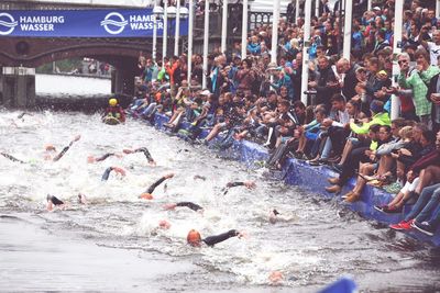 Group of people swimming in city