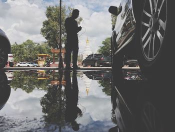 Reflection of trees in water against sky