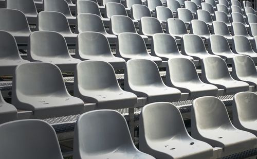 Full frame shot of empty chairs at stadium