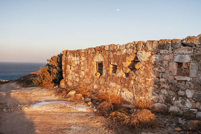 Abandoned house on the coast of milos island, cyclades, greece