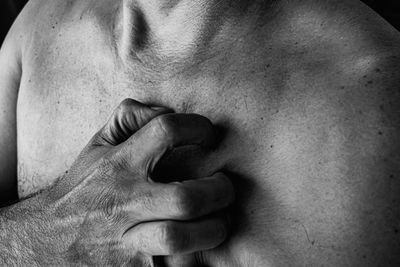 Close-up of hand on chest of man