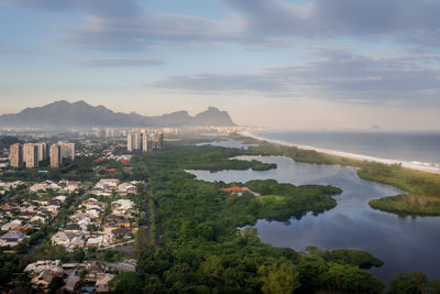 High angle view of townscape by sea against sky