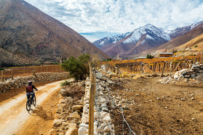 Woman mountain biking through elqui valley