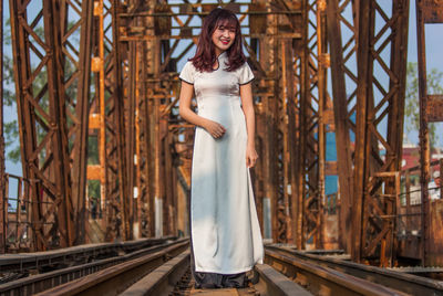 Full length portrait of woman standing outdoors