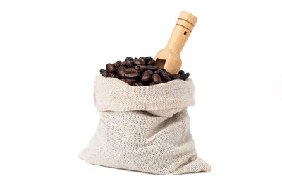 High angle view of roasted coffee beans against white background