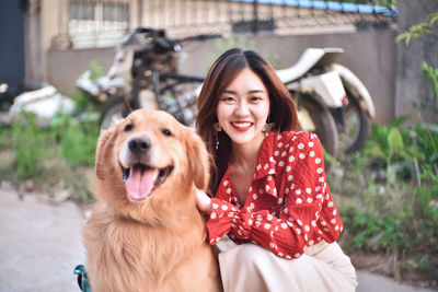 Portrait of smiling young woman with dog