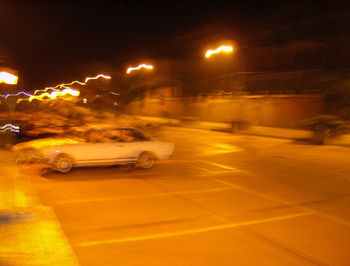 Illuminated car on snow at night