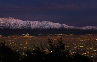 High angle view of cityscape and mountains against sky