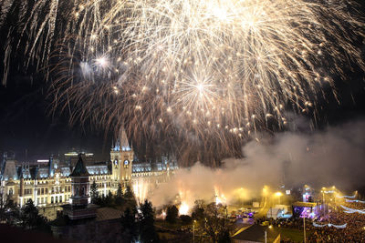Firework display in city at night