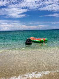 Water sport equipment in sea against sky