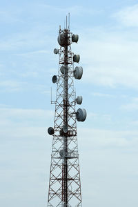 Low angle view of communications tower against sky