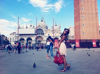 Woman standing in front of st mark cathedral against sky