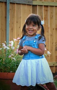 Portrait of smiling girl standing outdoors